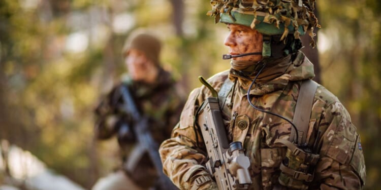 British special forces soldier with weapon take part in military maneuver. war, army, technology and people concept.