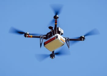 Drone carrying package.