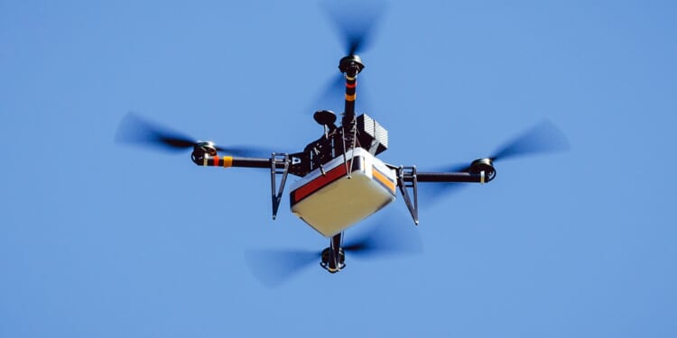 Drone carrying package.