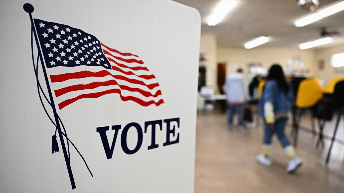 Voting booth with American flag.