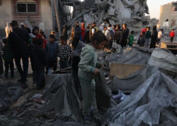 Palestinians sort through rubble in Gaza.