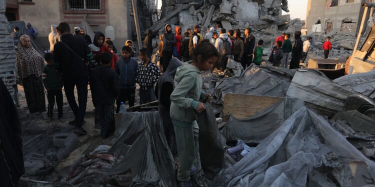 Palestinians sort through rubble in Gaza.