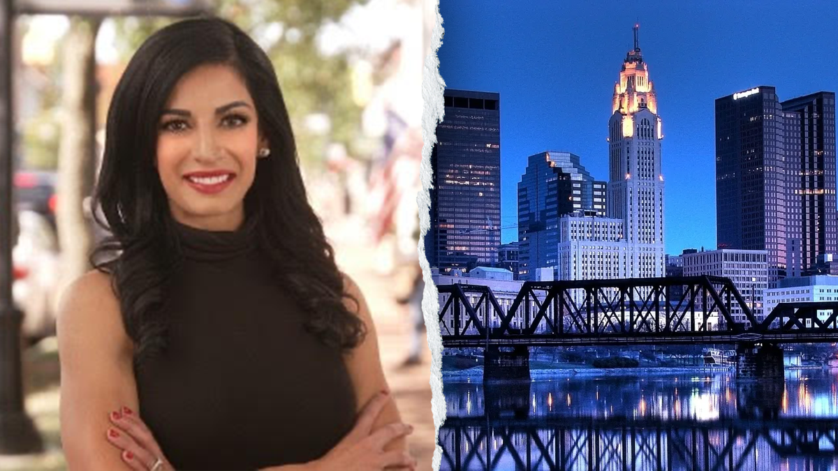 Mehek Cooke beside Columbus, Ohio, skyline at night