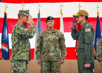 U.S. Army Lt. Gen. Joshua M. Rudd, deputy commander of U.S. Indo-Pacific Command, center, officiates the turnover between U.S. Navy Rear Adm. Greg Huffman, outgoing commander, Joint Task Force - Micronesia, right, to U.S. Navy Rear Adm. Josh Lasky, incoming commander, JTF-M, during a change of command ceremony at Marine Corps Base Camp Blaz Fitness Center, May 15.