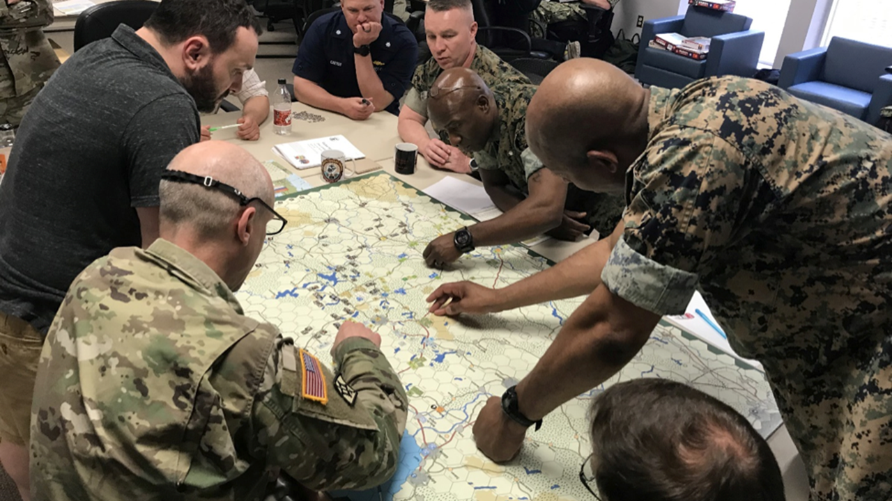 A group of soldiers conducting a wargame exercise.
