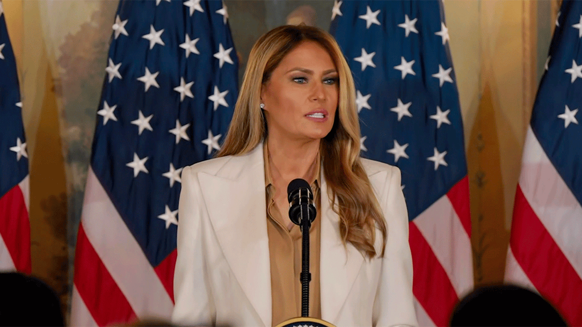 First Lady Melania Trump speaking at a podium