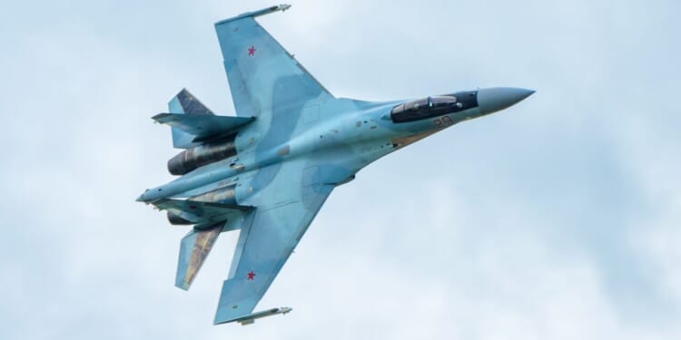 Modern Russian strike fighter Sukhoi Su-35 flying in sky. Military airplane of air force of Russia.