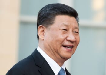 Chinese president Xi Jinping laughs on a trip to France