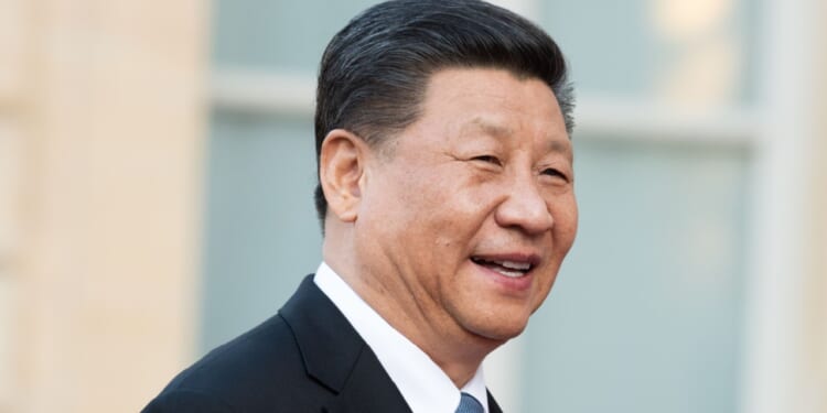 Chinese president Xi Jinping laughs on a trip to France