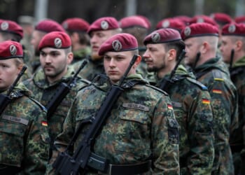 A group of German soldiers marching in a parade.