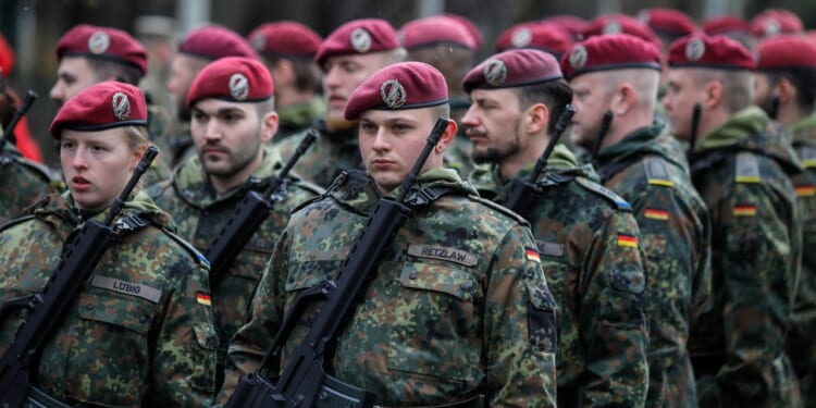 A group of German soldiers marching in a parade.