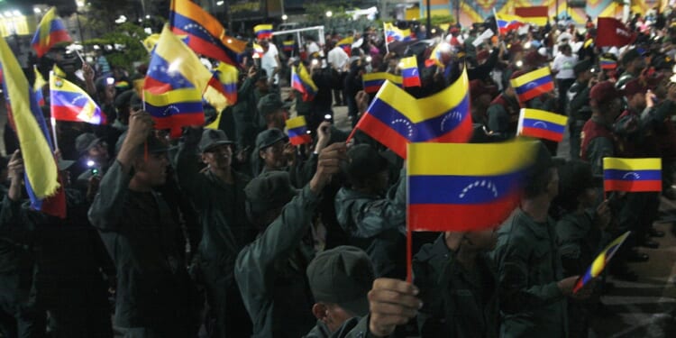 A group of Venezuelan soldiers carrying flags.