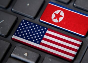 US and North Korean flags on a keyboard.