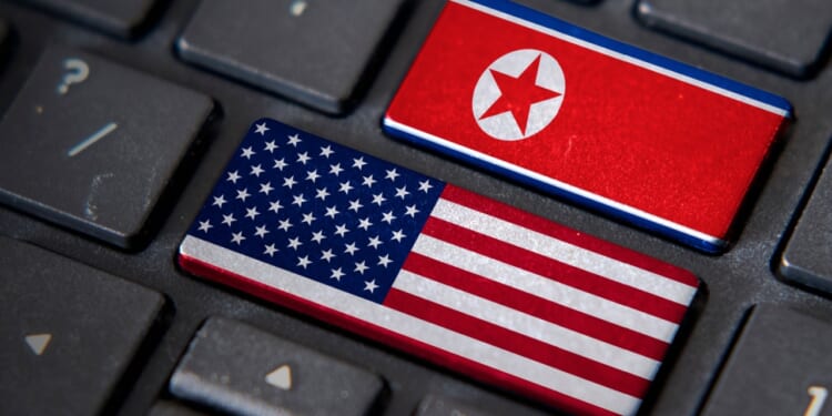 US and North Korean flags on a keyboard.