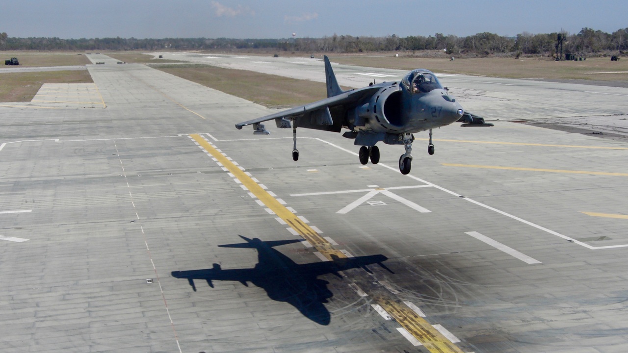 A Harrier jet landing at an airfield.
