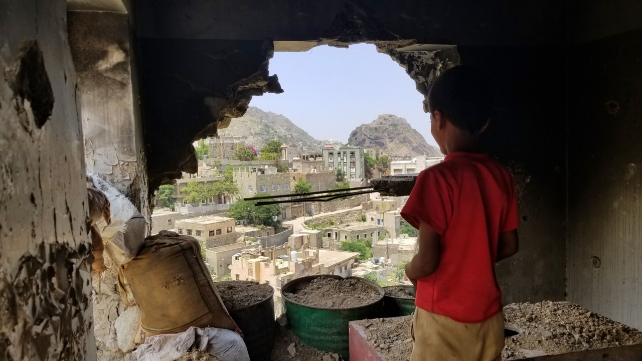 Child and ruined house in Yemen.