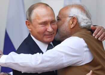 Russian president Vladimir Putin embraces Indian prime minister Narendra Modi.