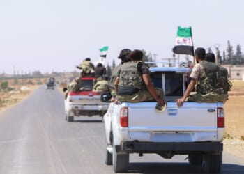 A group of Syrian rebels in a pickup truck.