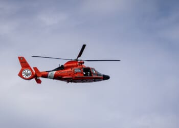 An MH-65 Dolphin helicopter in flight.