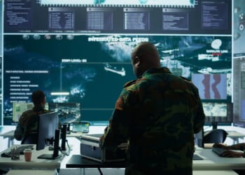 Military specialist in command post uses advanced technology and high tech gear to gather intelligence from satellite imagery and computer surveillance systems to communicate information. redefining economic warfare