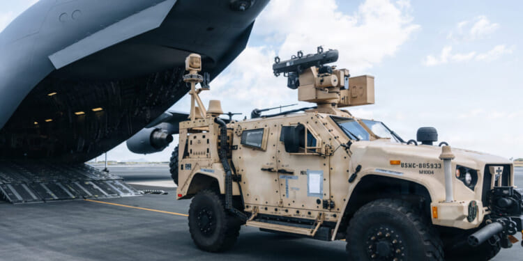 U.S. Airmen with 535th Airlift Squadron and Marines with 3rd Littoral Anti-Air Battalion, 3rd Marine Littoral Regiment, 3rd Marine Division, load a Marine Air Defense Integrated System, during a loading exercise onto a C-17A Globemaster III with the 535AS at Joint Base Pearl Harbor-Hickam, Hawaii, Oct. 24, 2025.
