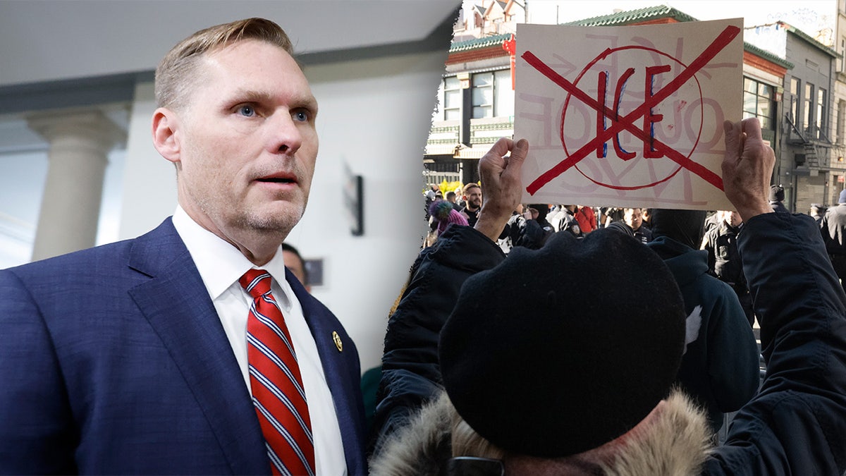Congressman Michael Guest, left, pictured next to a protester, right