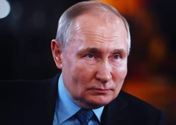 A portrait of Vladimir Putin, the president of Russia, looking directly at the camera.