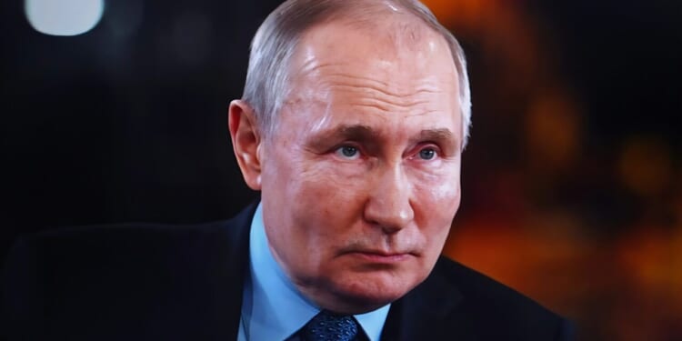 A portrait of Vladimir Putin, the president of Russia, looking directly at the camera.