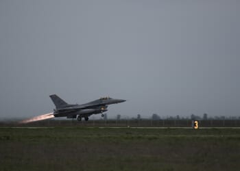 An F-16 Fighting Falcon taking off from a runway.