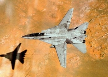 An F-14 Tomcat in flight over a desert.