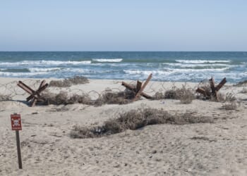 A fortified beach with mines and Czech hedgehogs.