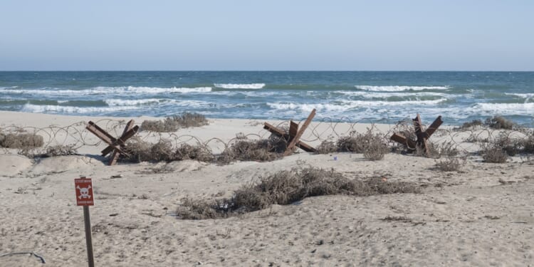 A fortified beach with mines and Czech hedgehogs.