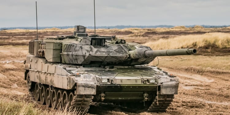 Leopard 2 armored tank in terrain.