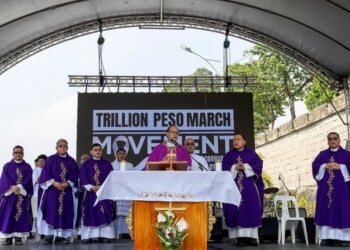 Cardinal Pablo Virgilio David with other bishops and clergy after celebrating Mass at the EDSA People Power Monument, Nov. 30, 2025, in Manila.