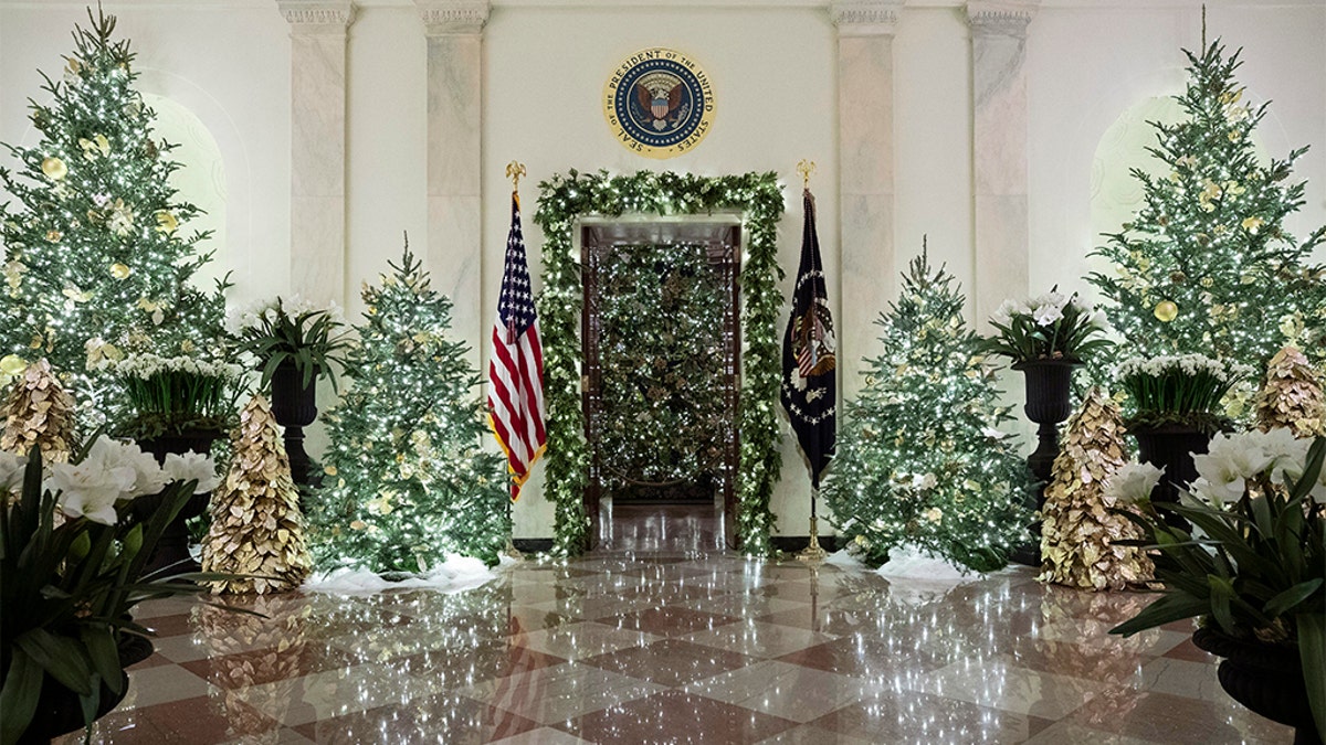 The official White House Christmas tree is decorated in the Blue Room, seen through the Cross Hall, during the 2019 Christmas preview at the White House, Monday, Dec. 2, 2019, in Washington.