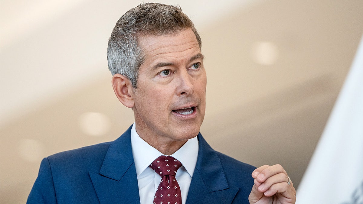 Transportation Secretary Sean Duffy speaks during a news conference inside an airport terminal.