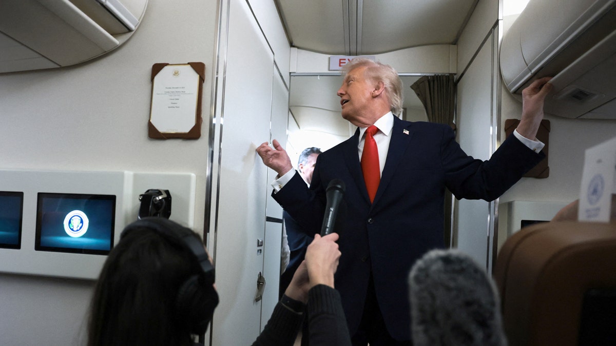 President Donald Trump knocks on AF 1 bathroom door