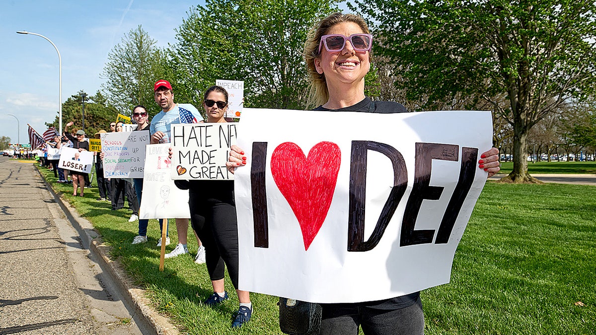 Demonstrators in Michigan protest Trump’s anti-DEI agenda.