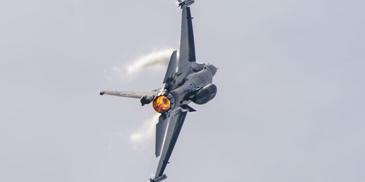 An F-16 Fighting Falcon performing a barrel roll.