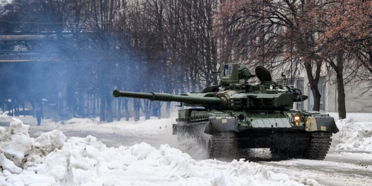 A tank firing its main gun in the snow.