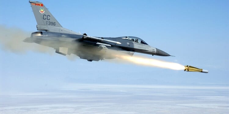 An F-16 Fighting Falcon fighter jet firing a missile.