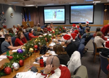 A group of NORAD employees participate in tracking Santa Claus.