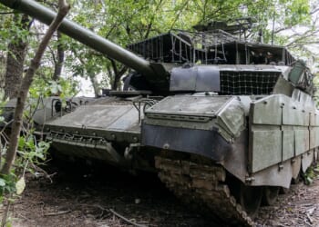 A Russian tank with improvised armor.