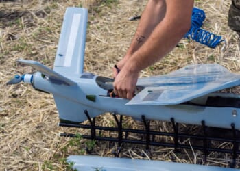 A soldier putting a drone together.