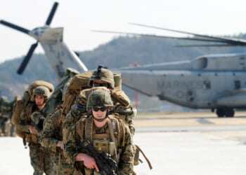 A group of US Marines leaving a helicopter.