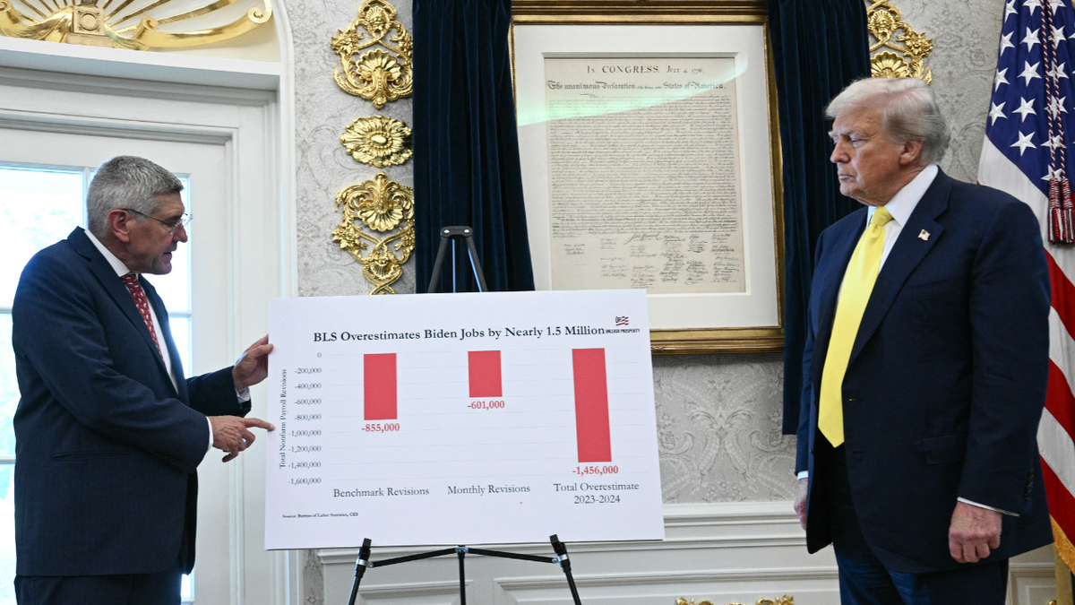 U.S. President Donald Trump and economist Stephen Moore look at data in the Oval Office