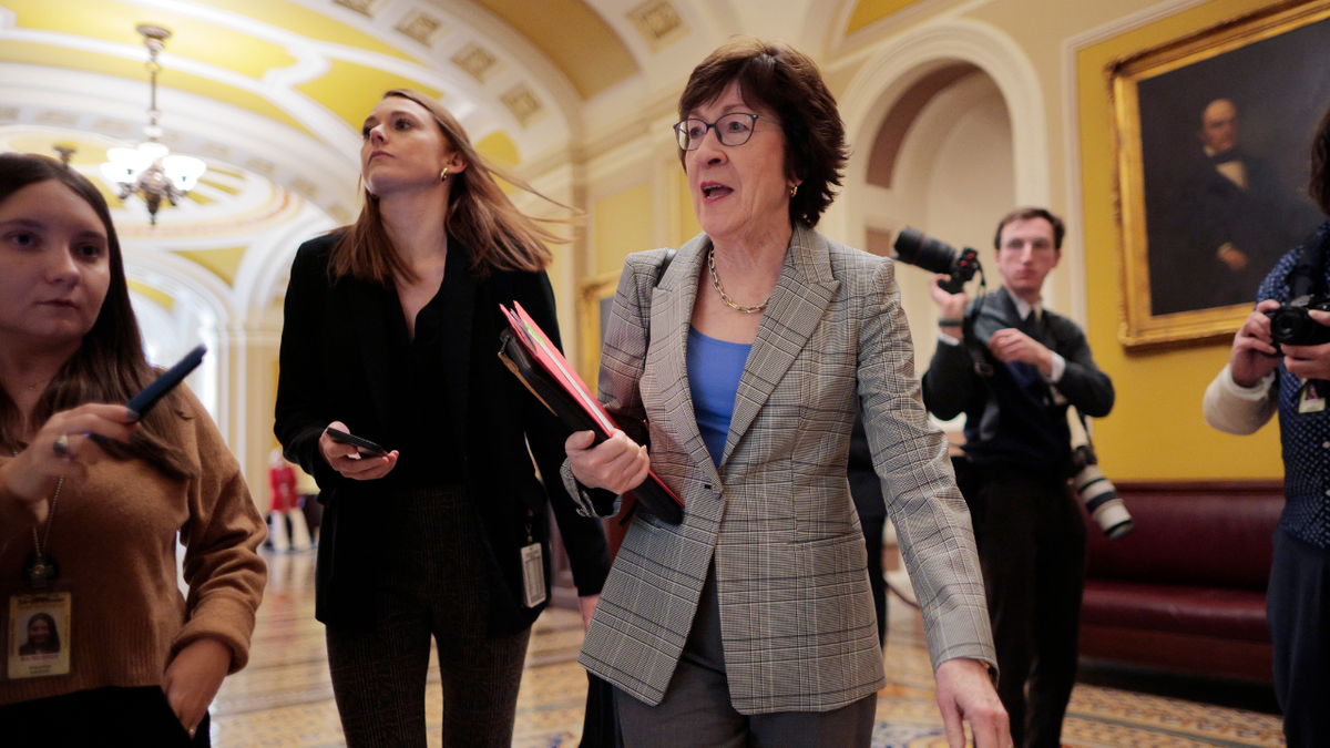 Maine Republican Sen. Susan Collins answers reporters questions as she walks to a meeting at the U.S. Capitol.