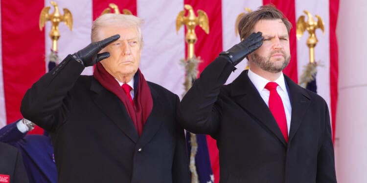 Trump and Vance saluting during a Veterans' Day observance.