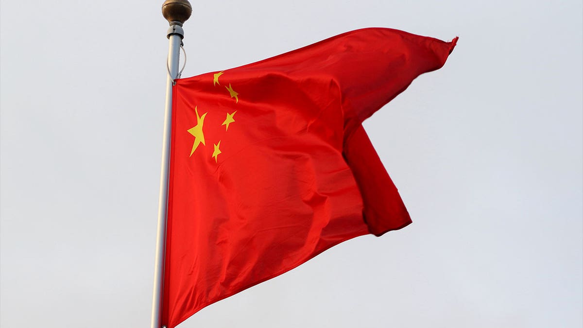 The Chinese communist flag waves in the wind.