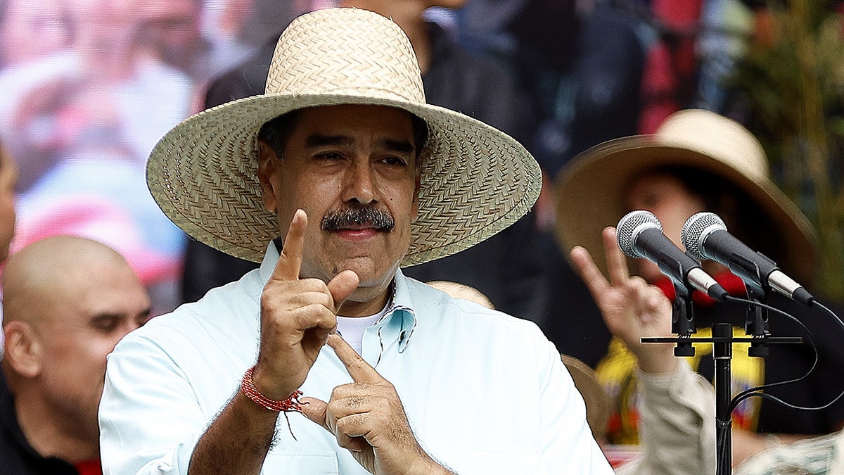 Venezuela President Nicolás Maduro stands near microphone